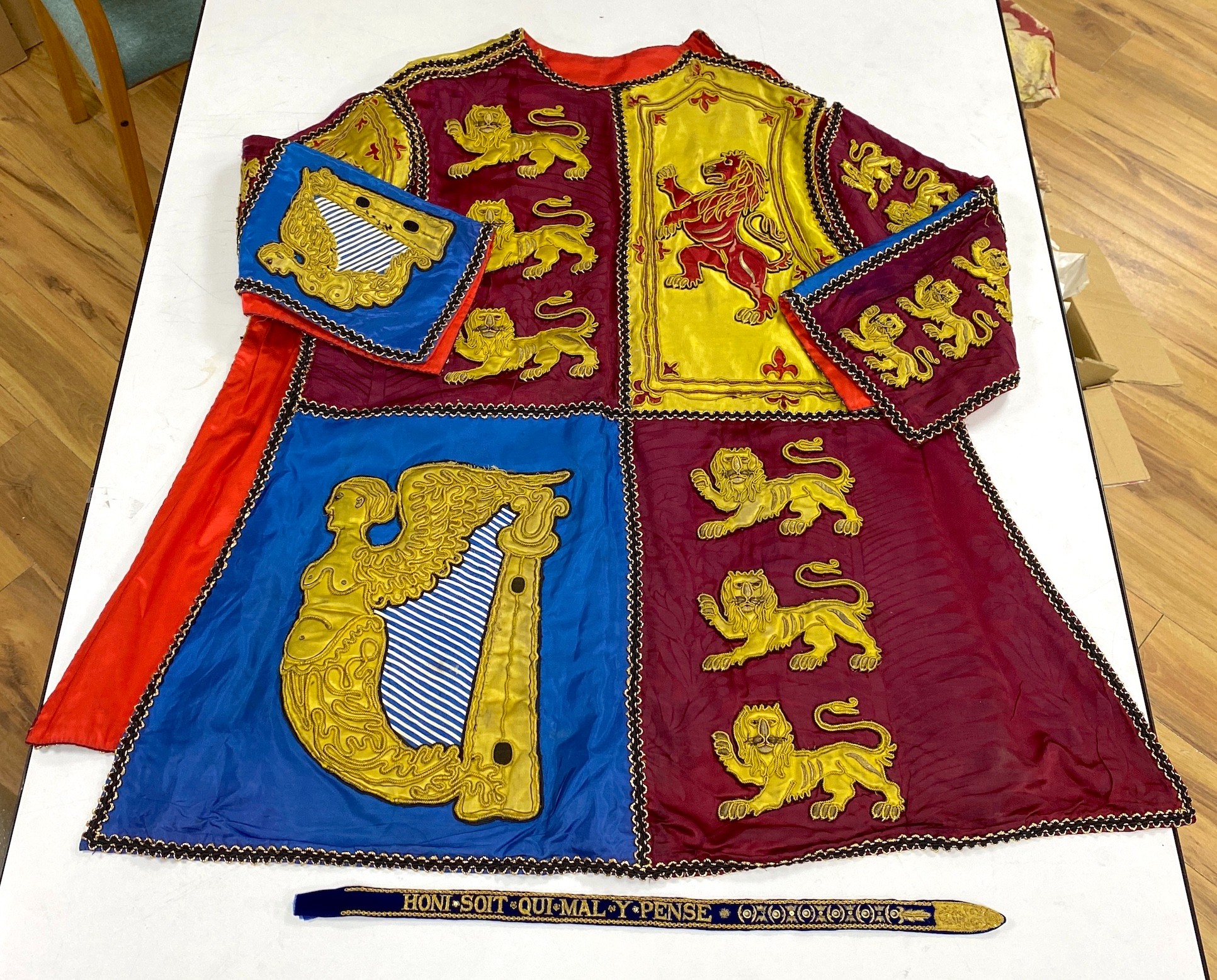 Two QEII Officer's of Arms of The Herald's College embroidered tabards and a similar silk garter, possibly worn for the Coronation of the Queen in 1953